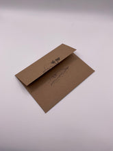 Load image into Gallery viewer, Hand-stamped kraft envelope with an island palm tree design, included with Paradise Visions greeting cards