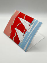 Load image into Gallery viewer, Regatta Waves greeting card standing at an angle, hand-drawn sailboats and red mountains