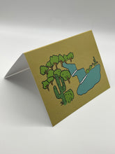 Load image into Gallery viewer, OASIS greeting card standing at an angle, hand-drawn cacti and blue stream