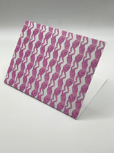 Load image into Gallery viewer, Finger Hearts greeting card standing at an angle, pink finger heart pattern